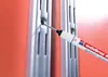 A close-up shot of a marker tip touching a metal surface with slots. Produktbild-Vorschau