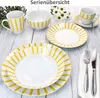 A collection of white ceramic tableware with yellow stripes, including plates, bowls, and a mug, arranged on a light wooden surface. Produktbild-Vorschau