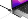 A close-up shot of a USB-C hub connected to a laptop. Produktbild-Vorschau