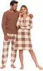 A man and a woman posing in matching pajamas. Produktbild-Vorschau
