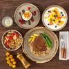 A collection of tableware and food items arranged on a wooden surface. Náhled obrázku produktu