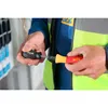 A person wearing a work vest and blue jacket is holding two parts of a screwdriver set. Náhľad obrázku produktu