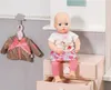 A baby doll is sitting on a pink dresser next to a jacket hanging on a cloud-shaped hook. Podgląd zdjęcia produktu
