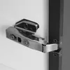 A close-up shot of a cabinet hinge attached to a white cabinet door and a dark frame. Voir les images du produit