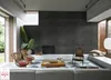 A modern living room with a fireplace, seating area, and large windows. Anteprima dell’immagine prodotto