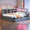 A child's bedroom with a grey bed frame, shelves, and pink cloud-themed wall art. Produktbild-Vorschau