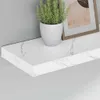 A white shelf with a marble pattern, a potted plant, and a framed picture. Produktbild-Vorschau