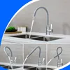 A collage of images showing a kitchen faucet with a flexible gray hose in various positions over a double sink. Produktbild-Vorschau