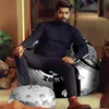 A man is sitting on a bean bag chair in a room with plants and furniture. Voir les images du produit