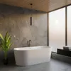 A modern bathroom with a freestanding bathtub, marble walls, and a large window. Náhľad obrázku produktu