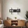 A wall-mounted TV bracket is shown above a wooden media console in a well-lit room. Voir les images du produit
