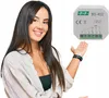 A woman is presenting a small electronic device. Podgląd zdjęcia produktu