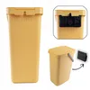 A collage of images showing a yellow plastic trash can with a lid and handle, and a black mounting bracket. Produktbild-Vorschau