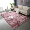 A living room scene with a pink rug, a sofa, a plant, and a side table. Náhled obrázku produktu