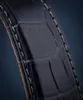 A close-up view of a dark blue alligator-patterned watch strap with white stitching. Podgląd zdjęcia produktu