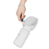 A hand holding a portable pet water bottle with a built-in bowl. Náhľad obrázku produktu