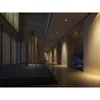 A modern, well-lit interior hallway with decorative sculptures and a water feature. Produktbild-Vorschau