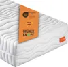 A close-up view of a white mattress with a prominent orange tag displaying certifications and branding. Produktbild-Vorschau