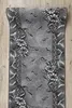 A runner rug with a floral and leaf pattern is laid out on a wooden floor. Produktbild-Vorschau
