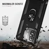 A black phone case with a ring holder is shown in a dynamic scene, appearing to be dropped onto a rocky surface. Debris is flying around the case. Produktbild-Vorschau