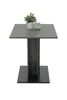 A square table with a concrete look top and a dark gray pedestal base, topped with a small potted plant and a glass jar. Produktbild-Vorschau