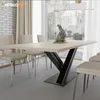 A dining table with chairs in a well-lit room with large windows. Podgląd zdjęcia produktu