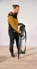 A man is holding a sanding tool in a carrying case. Podgląd zdjęcia produktu