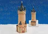 A miniature replica of the Eschenheimer Turm in Frankfurt, Germany, displayed in a snowy, winter-themed setting with a starry blue background. Produktbild-Vorschau