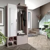 A modern hallway with a wardrobe, stairs, and plants. Náhled obrázku produktu