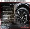 A car wheel with a rim cover splashing through water, with marketing text overlayed. Produktbild-Vorschau