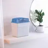 A white dehumidifier sits on a white shelf next to a potted plant and a mirror. Anteprima dell’immagine prodotto