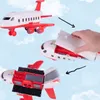 A toy airplane is shown in three stages: assembled, with the top being opened, and with the bottom compartment open. Produktbild-Vorschau