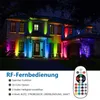 A house illuminated by colorful LED lights at night, with a remote control shown in the foreground. Náhled obrázku produktu