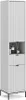 A tall, narrow white cabinet with a fluted design on its doors and drawer fronts, standing on thin black legs. Náhled obrázku produktu