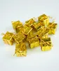 A pile of small, gold-wrapped gift boxes. Náhled obrázku produktu
