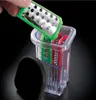 A hand is holding a grater attachment over a clear container filled with various attachments for a food processor. Produktbild-Vorschau