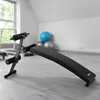 A black sit-up bench in a gym or fitness room. Náhľad obrázku produktu