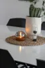 A table setting with a candle, a cactus in a pot, and an hourglass. Produktbild-Vorschau