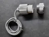 A close-up shot of a light socket and a connecting piece, with a coiled cable on a dark gray surface. Podgląd zdjęcia produktu