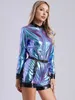 A woman modeling a metallic jumpsuit. Podgląd zdjęcia produktu