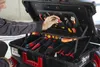 A person is reaching into an open tool case, selecting a tool. Produktbild-Vorschau