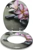 An open toilet seat with a decorative design of pink flowers and gray stones. Produktbild-Vorschau
