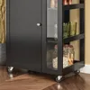 A close-up view of the bottom section of a black kitchen cart with glass doors and shelves. Produktbild-Vorschau