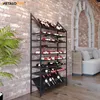A wine rack filled with bottles of wine in a room with a brick wall and a sofa. Náhľad obrázku produktu