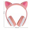 A pair of pink and white cat-ear headphones are shown against a white background. Dimensions are indicated by lines and text. Náhľad obrázku produktu