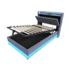 A bed frame with the mattress support raised, showing the storage space underneath and LED lighting around the base and headboard. Produktbild-Vorschau