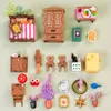 A collection of miniature dollhouse furniture and accessories arranged on a light green background. Podgląd zdjęcia produktu