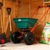 Gardening tools and a spreader inside a wooden shed. Produktbild-Vorschau