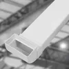 A close-up view of a white plastic cable duct with a rectangular opening, set against a blurred industrial background. Náhled obrázku produktu
