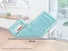 A turquoise mop head with a white and red Leifheit logo is shown lying on a wooden floor, angled towards a glass door. Produktbild-Vorschau